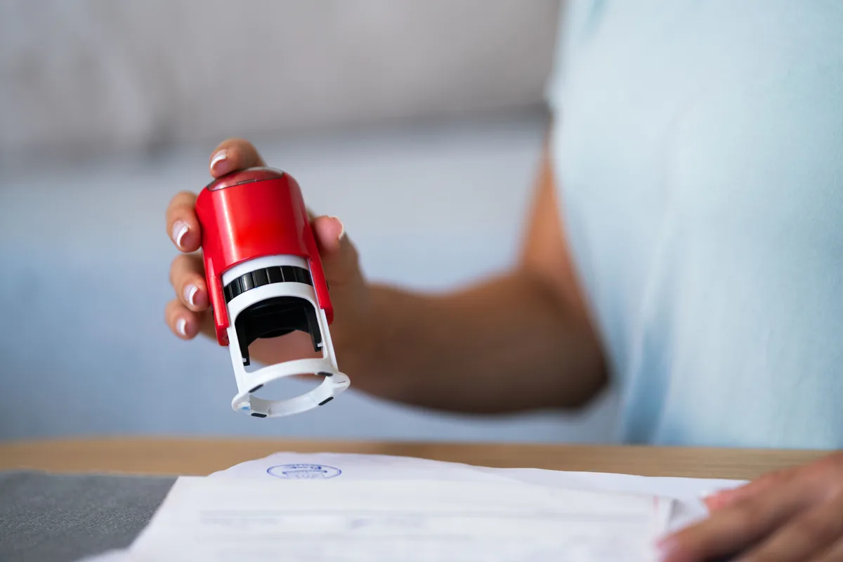 Notary public stamping a document — Houston notary fees and services